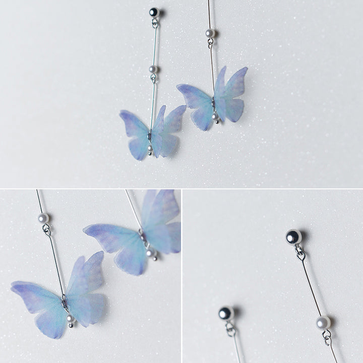 Boucles d'oreilles pendantes longues avec papillon bleu et perle - Femme - Argent 925. Un bijou poétique évoquant le frémissement d'un papillon en plein vol.