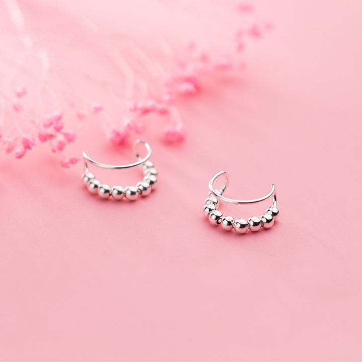 Boucle d'oreille cartilage sans trou, double anneau perle métallique - Femme - Argent 925. Élégance et innovation réunies dans ces boucles d'oreille en argent. Luxe discret sans perçage.