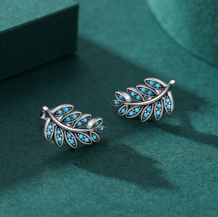 Boucle d'oreille grimpante feuille pierre turquoise - Argent 925. Design unique en forme de feuilles avec pierres turquoises incrustées. Élégance naturelle et féminine.