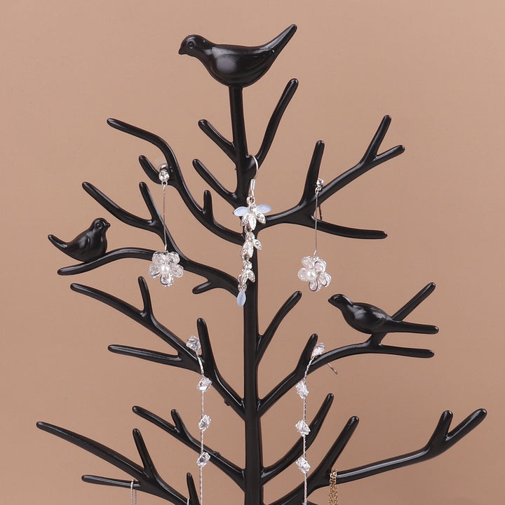 Présentoir arbre oiseaux pour boucles d'oreille, accessoire rétro et coloré pour organiser vos bijoux avec style. Hauteur 32,5 cm, diamètre plateau 16,5 cm. Matériau acrylique.
