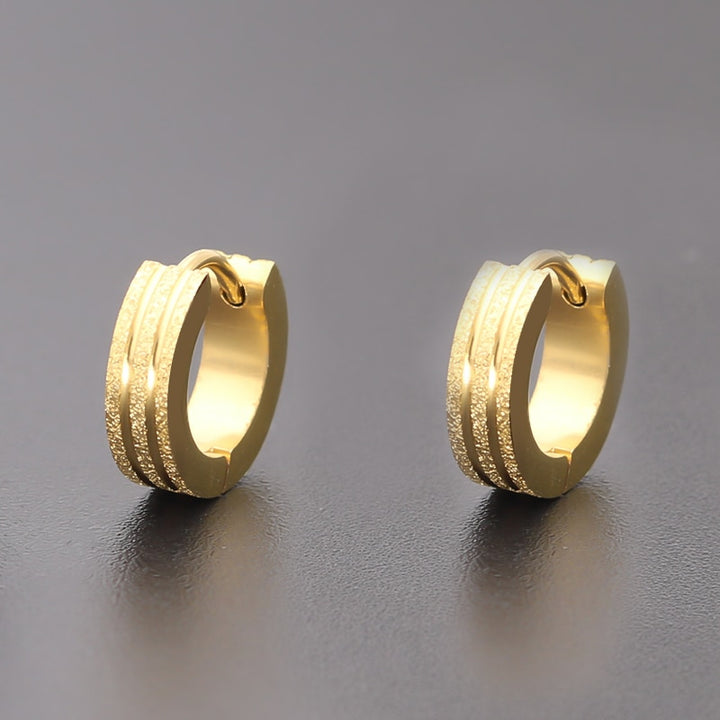 Boucle d'oreille anneau large bi matière - Homme - Acier inoxydable. Trois anneaux pailletés séparés par deux fins anneaux métallisés. 9 x 4 mm, 3,6 g.