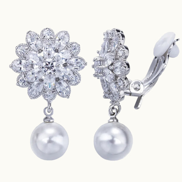 C'est une paire de boucles d'oreille à clip sans trou. Elles sont composées d'une fleur ornée de diamants et d'une perle pendante ronde. 