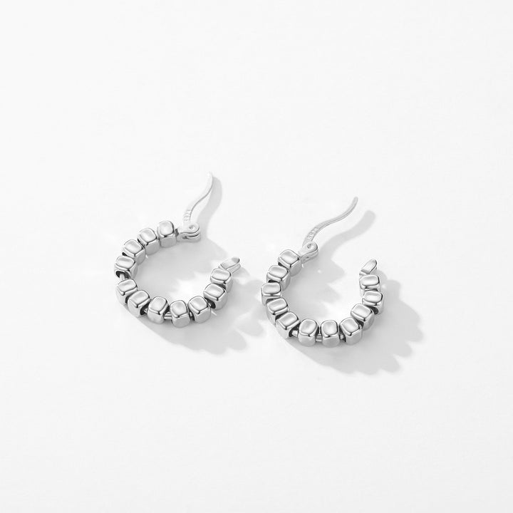 Boucles d'oreille créoles en argent 925 avec détails cubiques. Design moderne et géométrique, idéal pour une allure contemporaine et chic. 18 mm, 2,7 g. Femme.