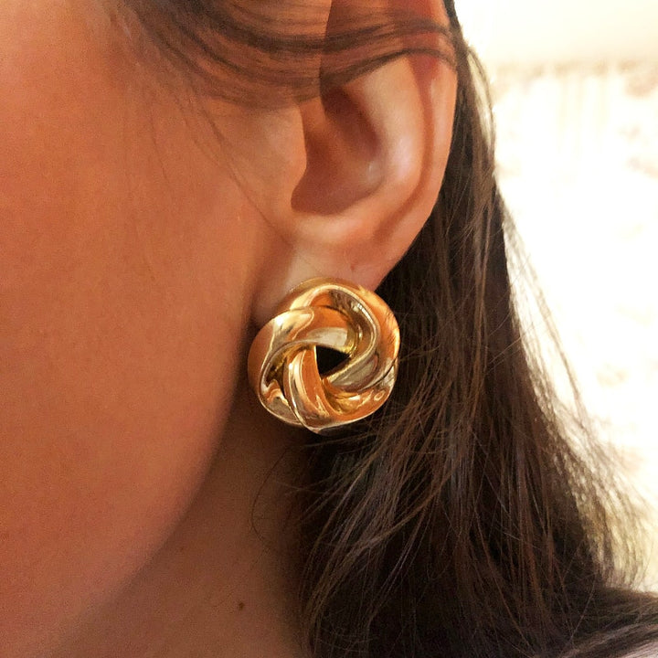 Boucle d'oreille ronde torsadée - Femme, une ode à la féminité moderne avec une conception unique qui reflète la lumière. Durabilité et légèreté grâce à l'alliage de zinc. 3,5 cm de dimensions, 17,1 g de poids. Un bijou intemporel pour sublimer chaque jour.